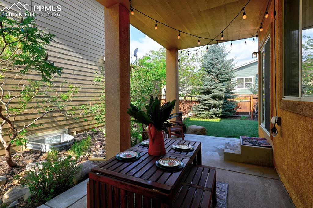 Image 17 of 33: Covered patio creates a warm and inviting space for outdoor dining and rela