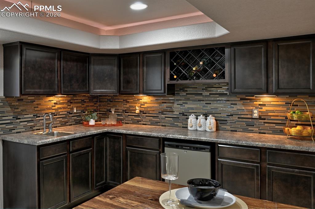 Image 27 of 33: Ideal for entertaining, this well appointed wet bar offers great prep space