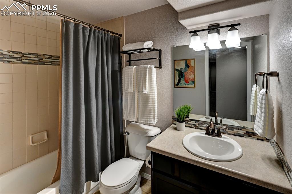 Image 28 of 33: Basement bath with tub and shower combo