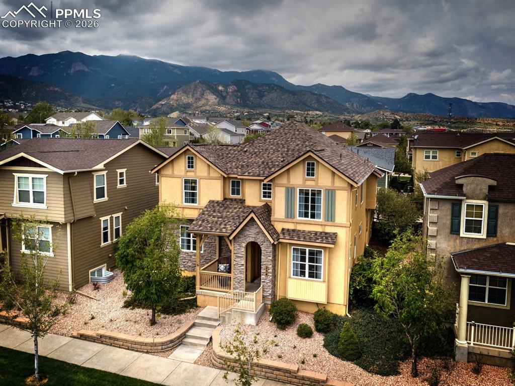 Image 32 of 33: Aerial view of home with mountain backdrop