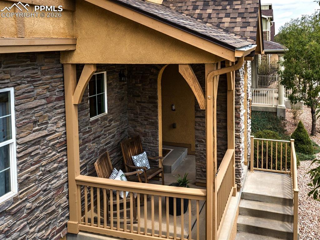 Image 4 of 33: Inviting front porch with outdoor seating, offering a warm and welcoming sp