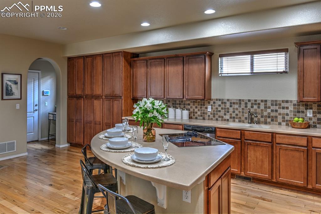 Image 8 of 33: Full wall of cabinetry offers abundant storage, with seamless connection to