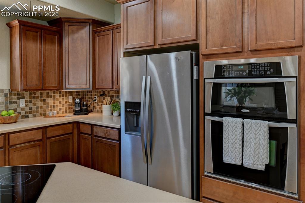 Image 9 of 33: Stainless double ovens and refrigerator add both style and everyday conveni