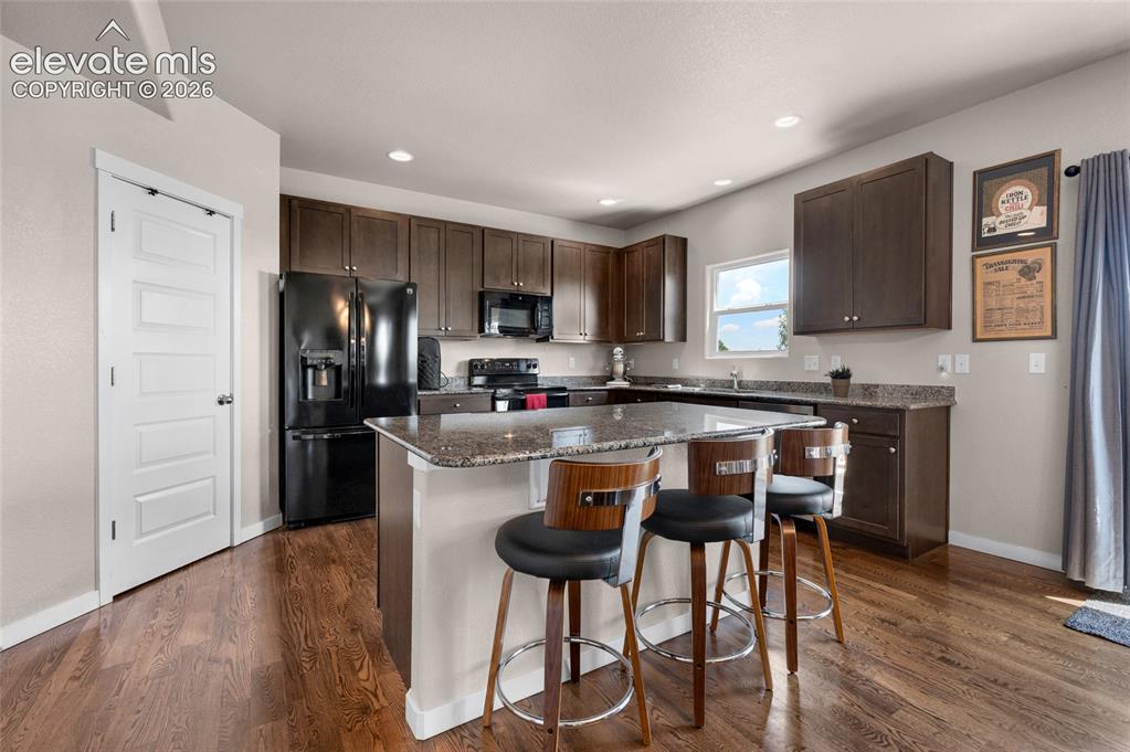 Image 11 of 47: Kitchen has a spacious center island with a counter bar