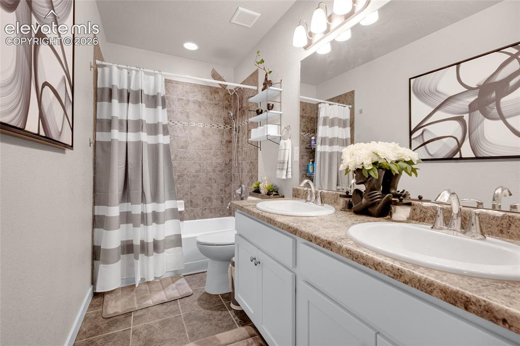 Image 27 of 47: Double vanity bathroom near upstairs bedrooms