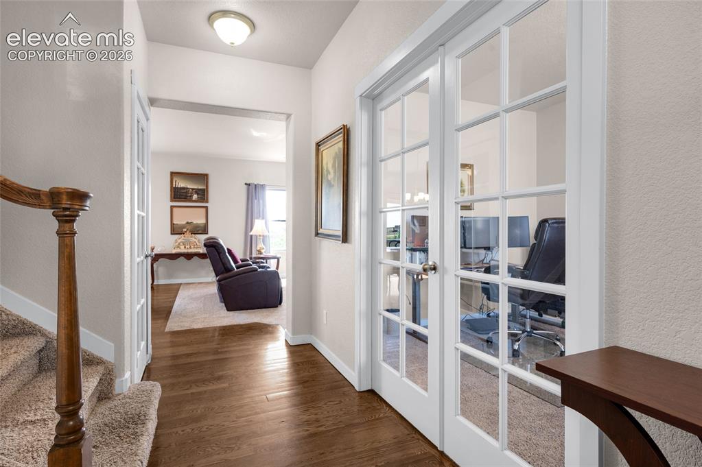 Image 3 of 47: Beautiful entry with hardwood floor. French door entry to office is on rig