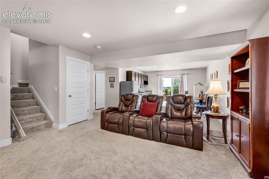 Image 32 of 47: Carpeted living area with recessed lights