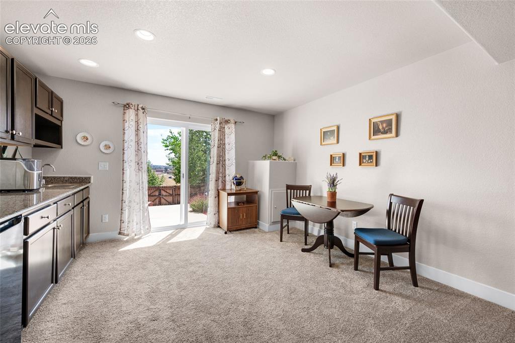 Image 33 of 47: Living room blends into kitchenette and dining area