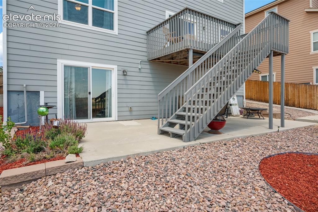 Image 44 of 47: Lower level also has a small patio and stairs that will take you to upper d