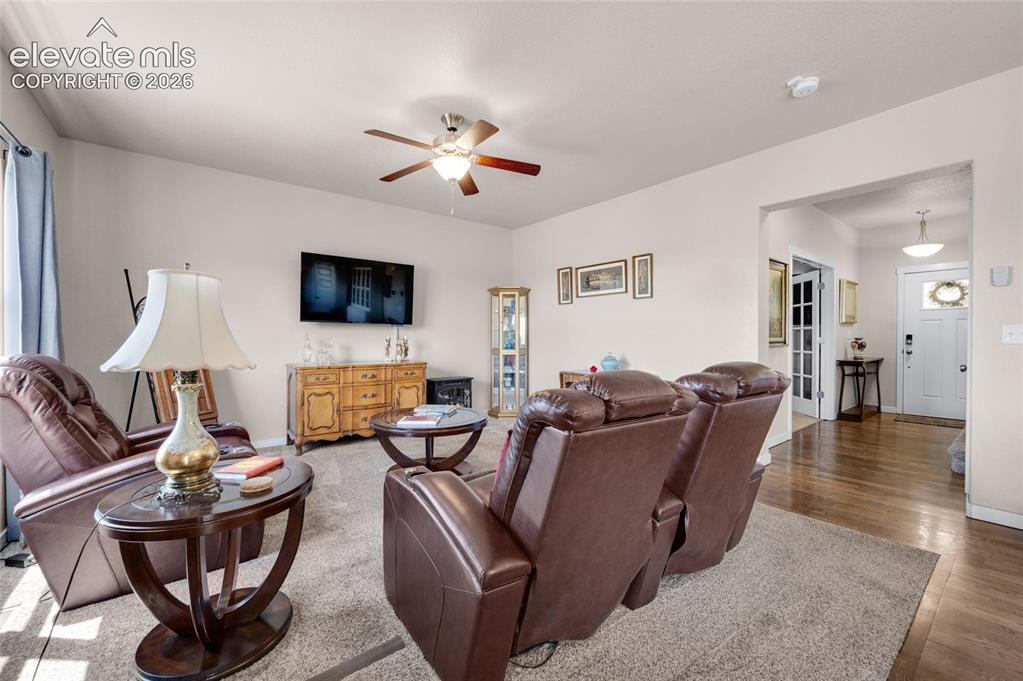 Image 9 of 47: Livingroom has a ceiling fan