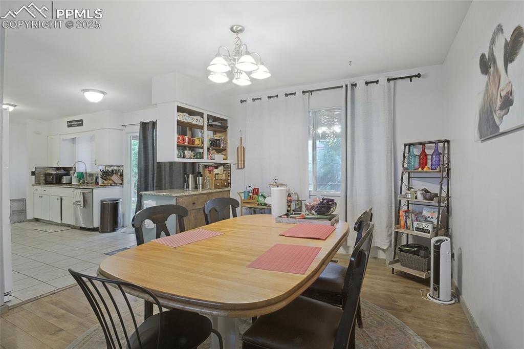 Image 10 of 35: Dining area with healthy amount of natural light, a chandelier, and light w