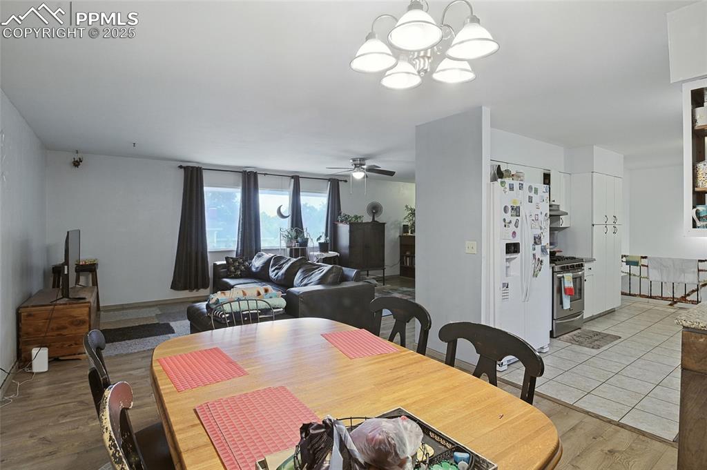 Image 12 of 35: Dining space featuring a chandelier, light wood finished floors, and a ceil