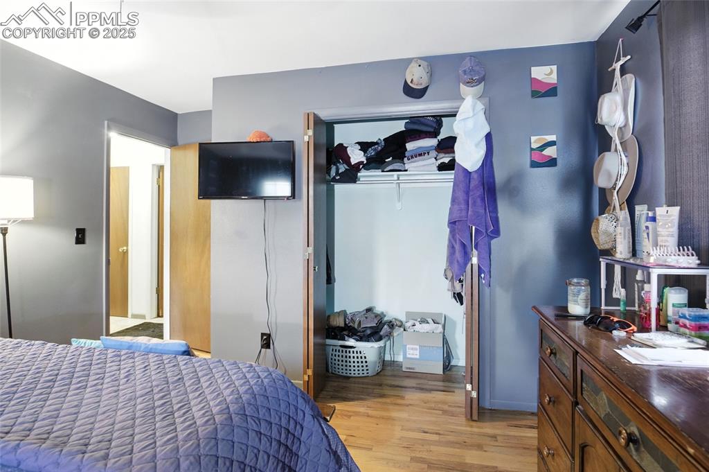 Image 21 of 35: Bedroom with light wood-style floors and a closet