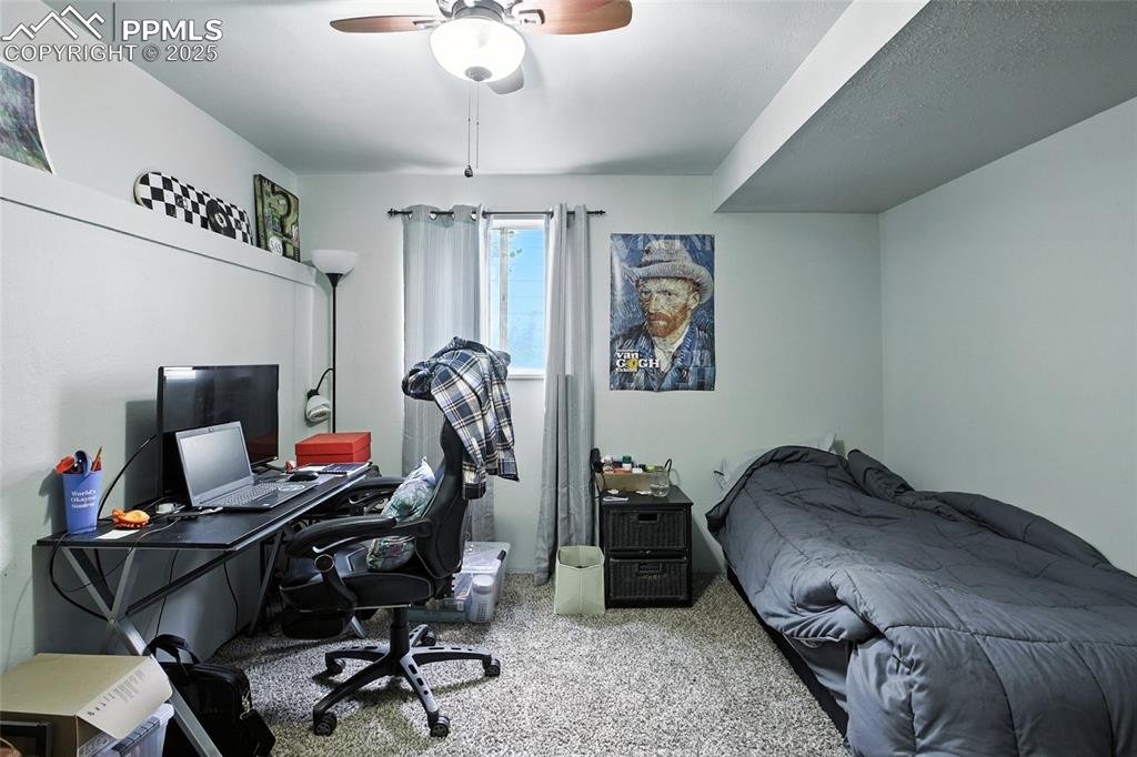 Image 26 of 35: Bedroom with carpet floors, an office area, and ceiling fan