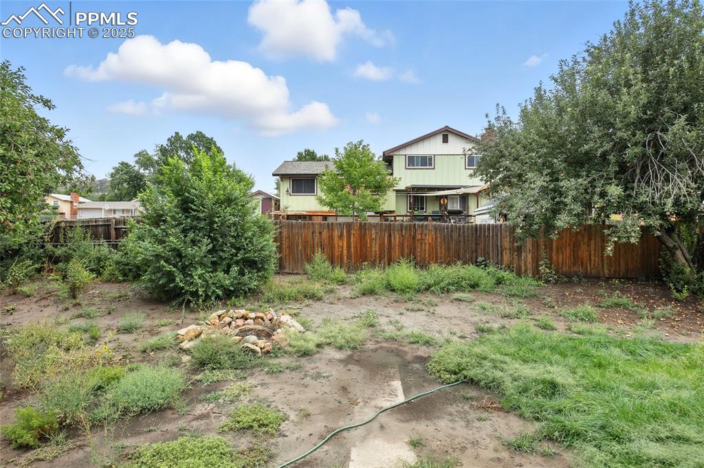 Image 32 of 35: View of fenced backyard