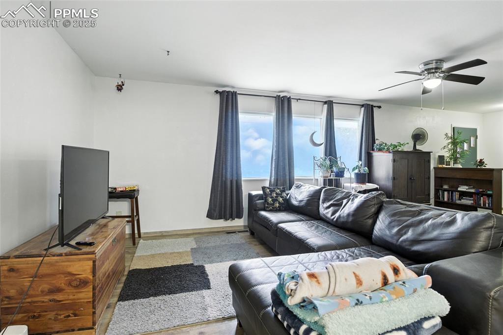 Image 8 of 35: Living room featuring ceiling fan and baseboards