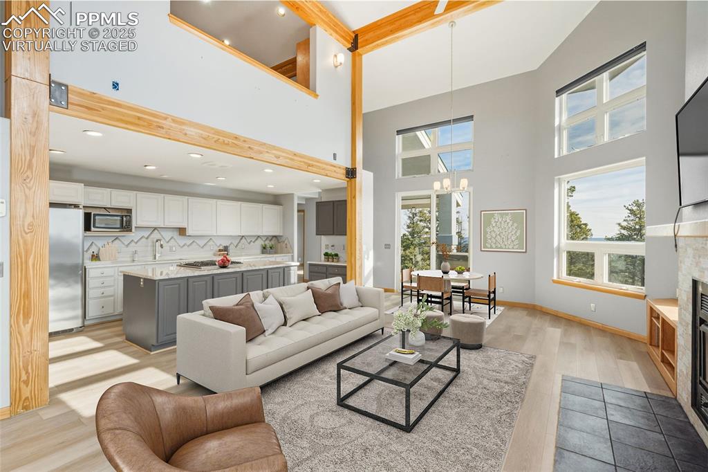 Image 11 of 50: Virtually Staged - Living area featuring a glass covered fireplace, light w