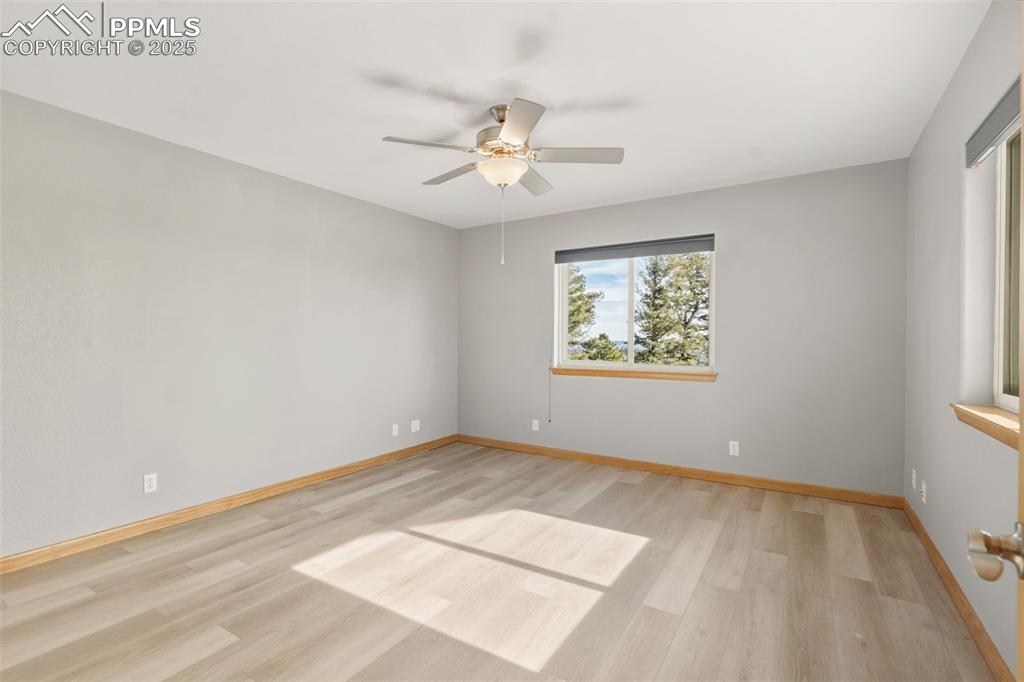 Image 32 of 50: Unfurnished room with light wood-style floors and ceiling fan
