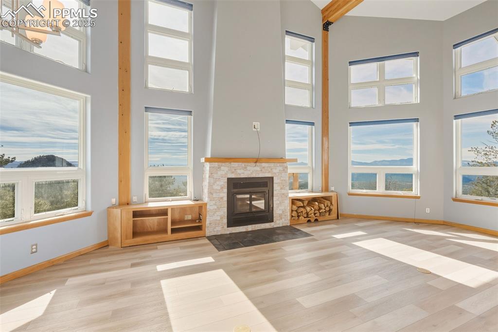 Image 47 of 50: Unfurnished living room featuring a fireplace with flush hearth, wood finis