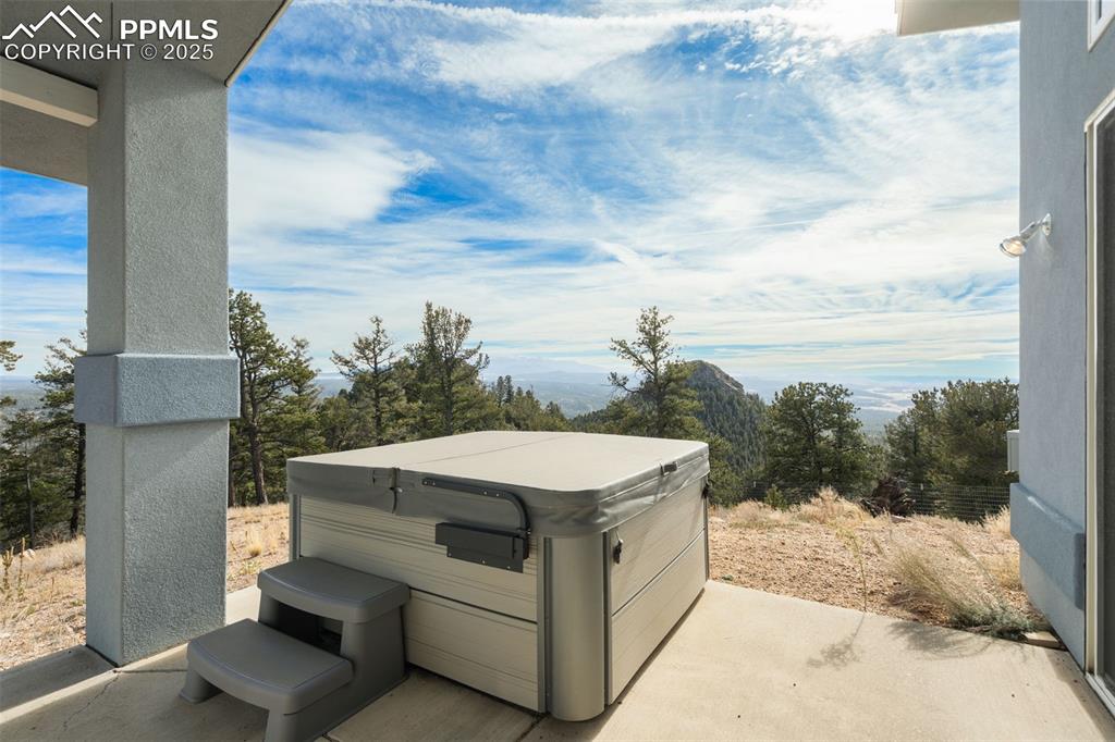 Image 7 of 50: View of patio with a hot tub