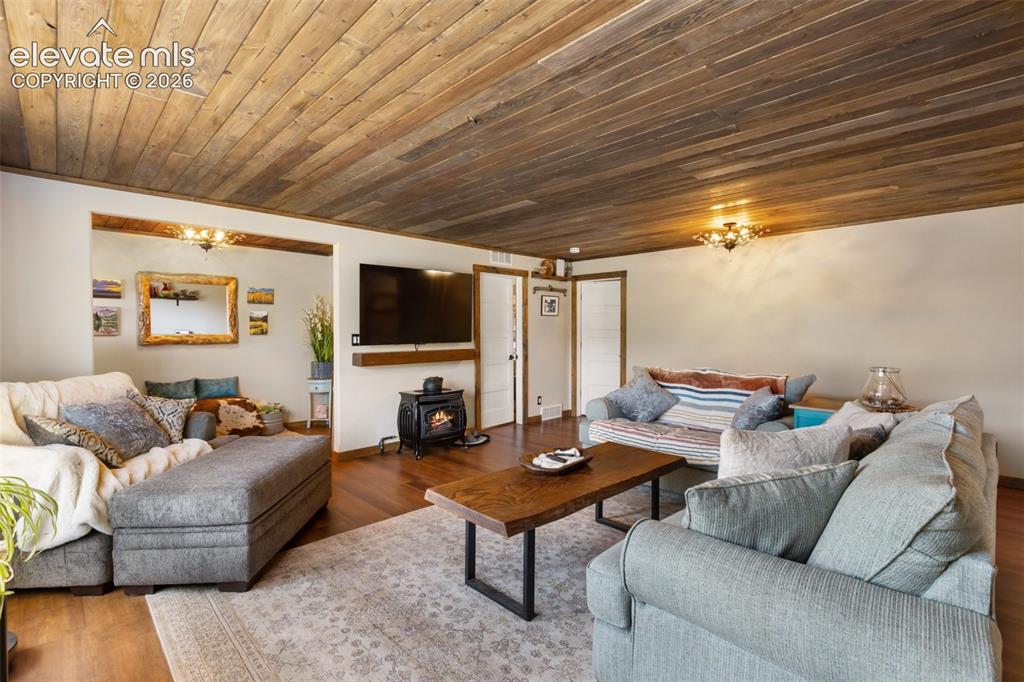 Image 11 of 50: Custom lighting and ceiling wood work.