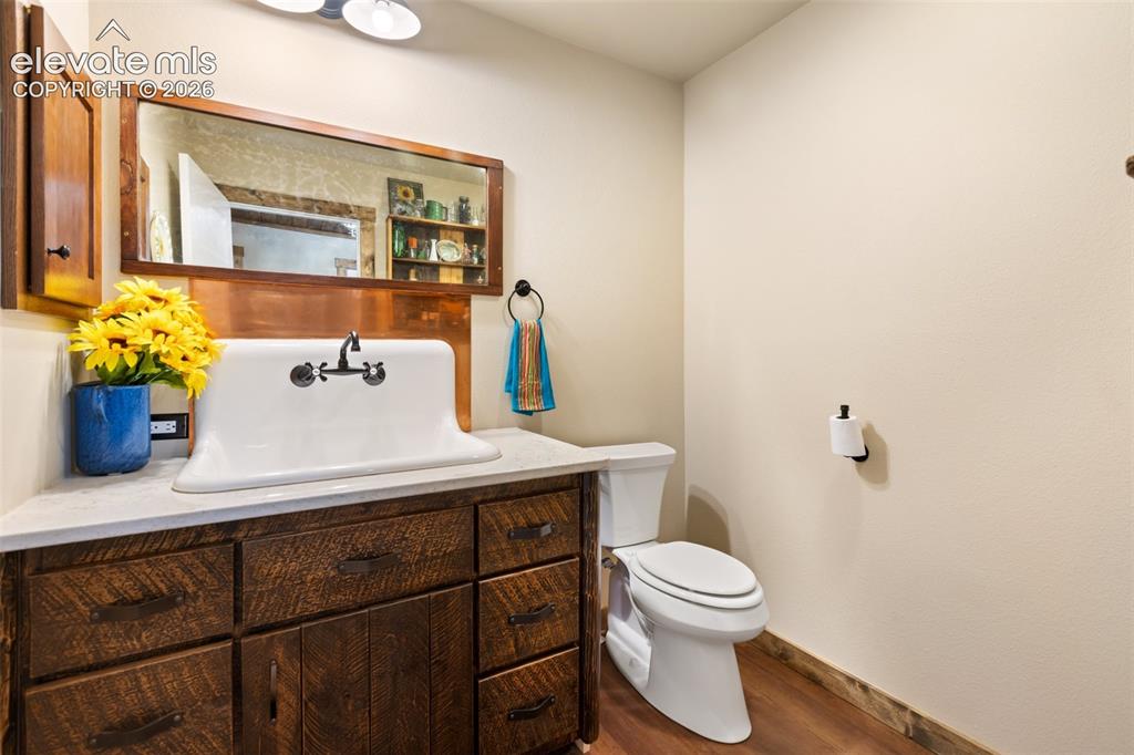 Image 14 of 50: Guest bath with custom farm house sink.