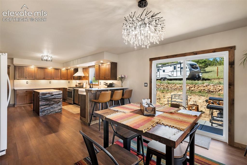 Image 18 of 50: Open flow from the kitchen to the dining room with walk-out.