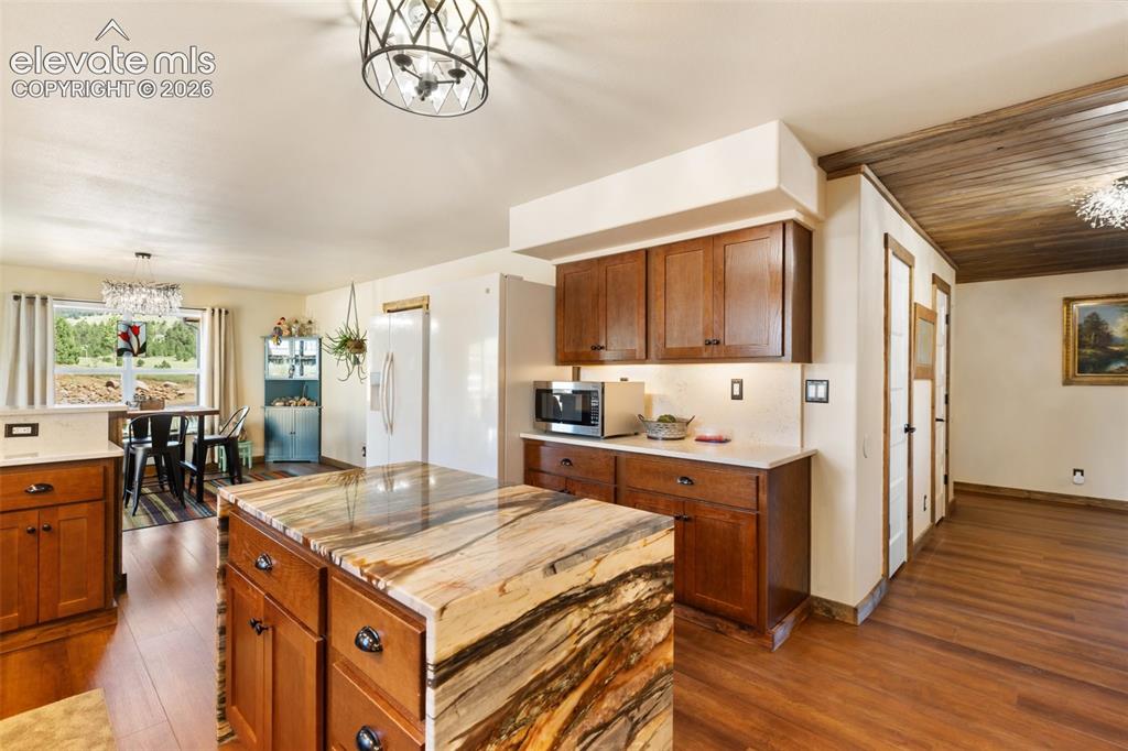 Image 21 of 50: Kitchen flows to the living room to the right and the garage and laundry sp