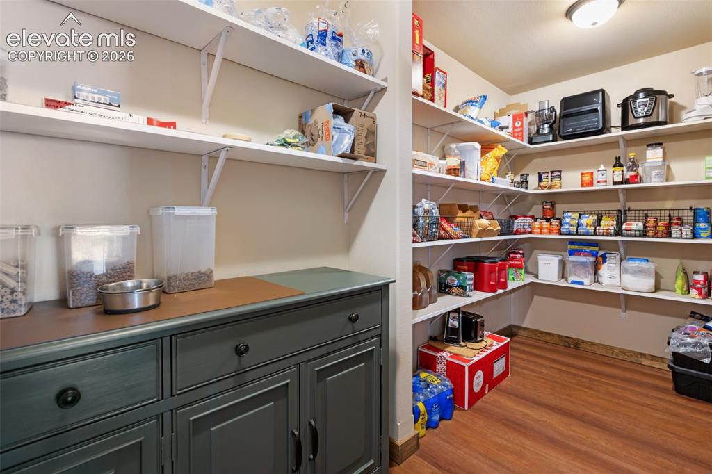 Image 24 of 50: Pantry space with storage and daily use cabinets.