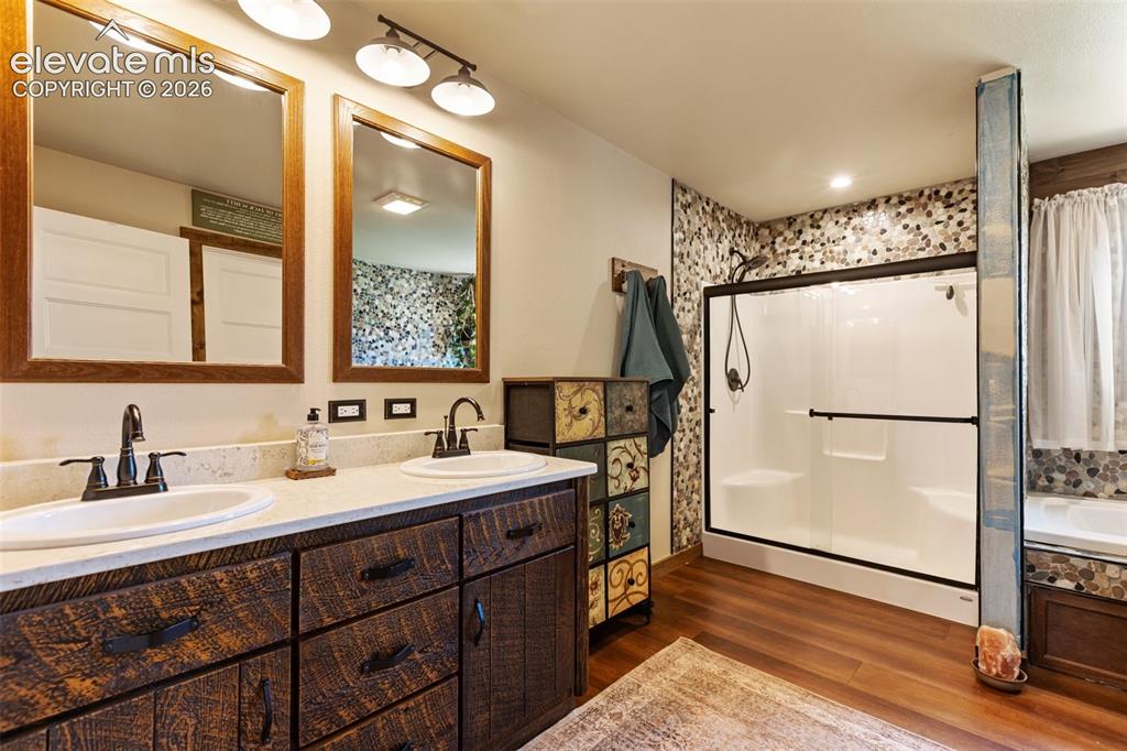 Image 28 of 50: Primary ensuite bath with walk in shower and tub