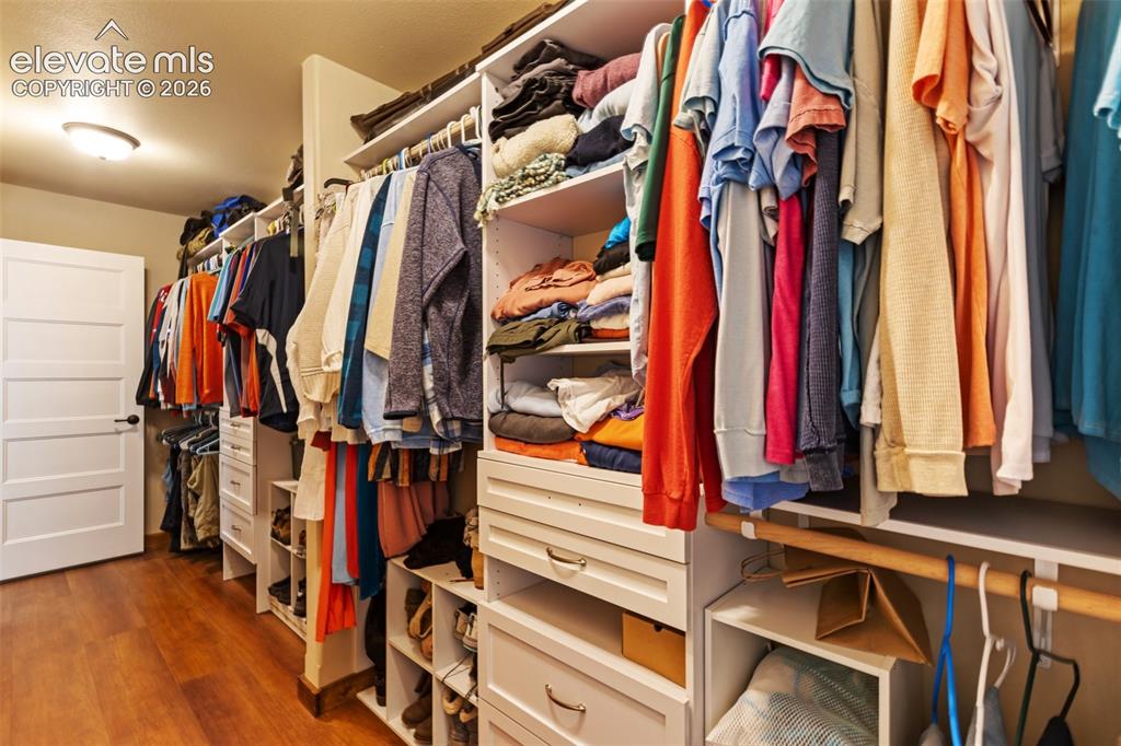 Image 31 of 50: Primary bedroom walk-in closet