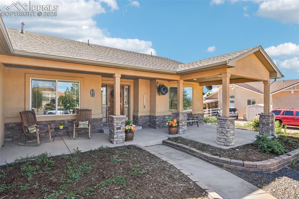 Image 2 of 45: This inviting front porch has options for dining, watching the sun set, and