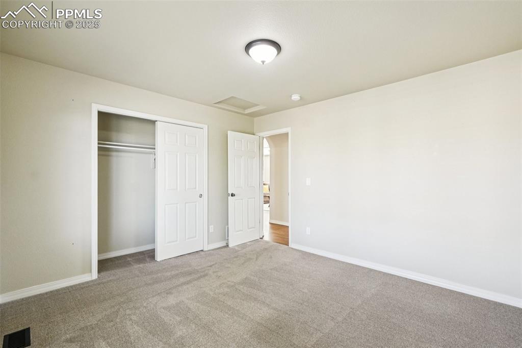 Image 24 of 45: This main level secondary bedroom is on the other side of the main level f