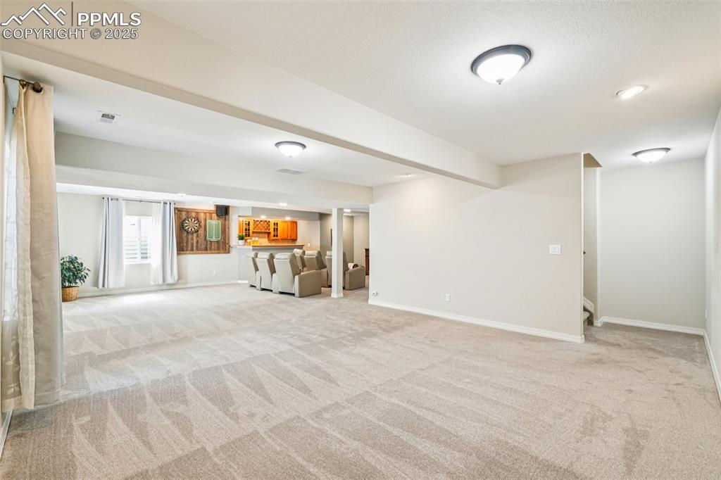 Image 30 of 45: The basement living area is huge with room for multiple uses.