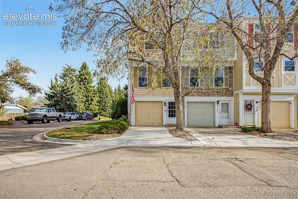 Image 1 of 42: Two-story townhome featuring a stone facade and siding exterior