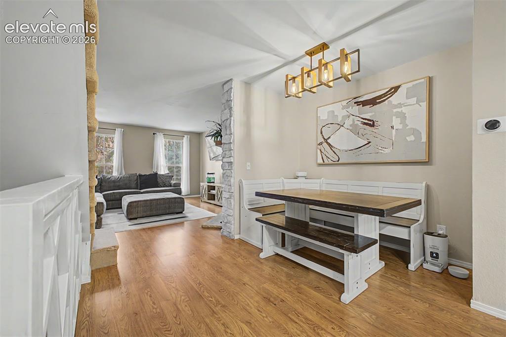 Image 12 of 42: Open-concept interior featuring wood-finish flooring, a modern linear chand