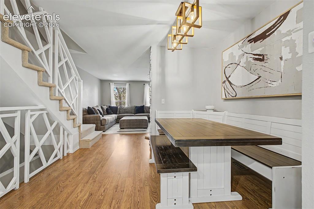 Image 13 of 42: Open-concept living area with wood-finish flooring