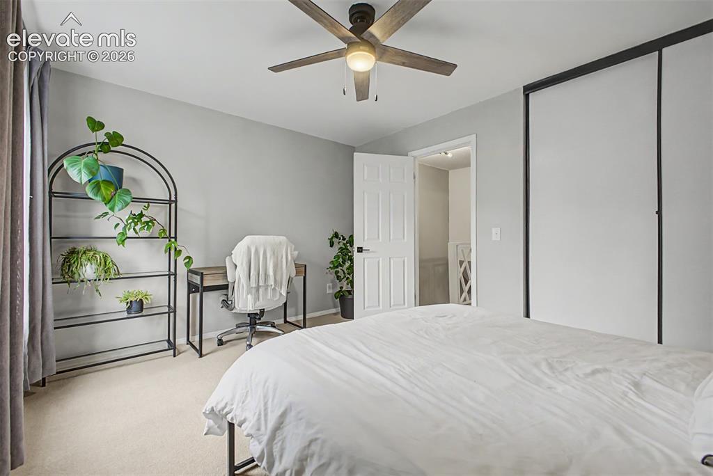 Image 26 of 42: Carpeted interior space featuring a ceiling fan with light fixture, light g