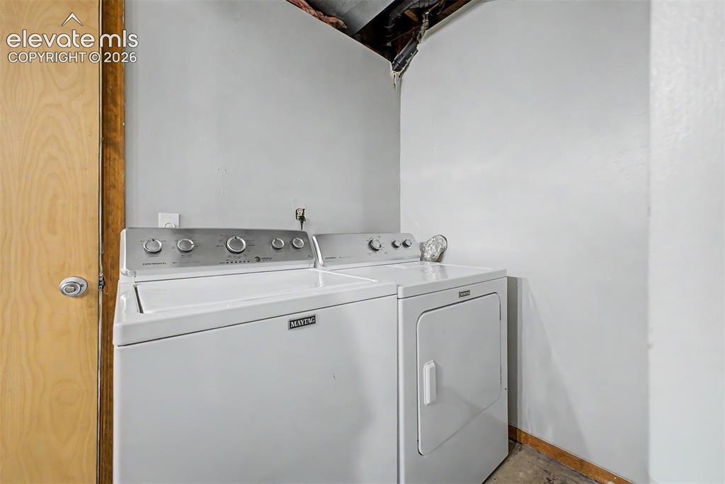 Image 31 of 42: Dedicated laundry area featuring a light-colored wood door frame and light