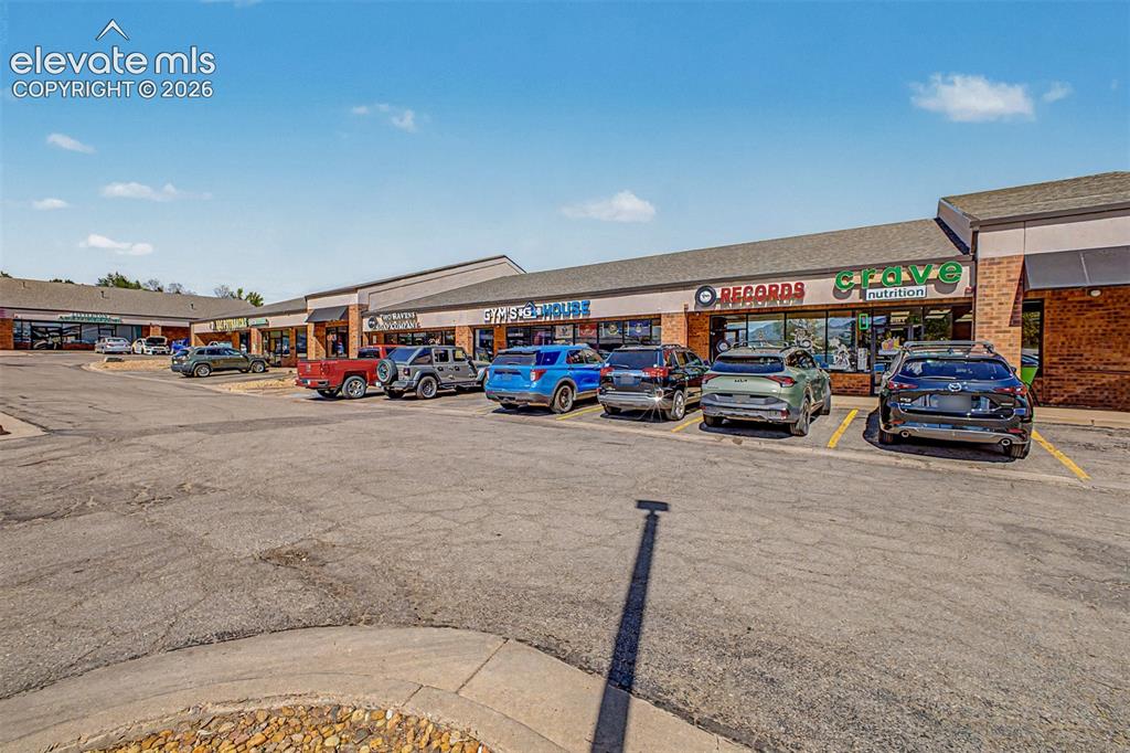 Image 38 of 42: Commercial strip center with multiple retail storefronts