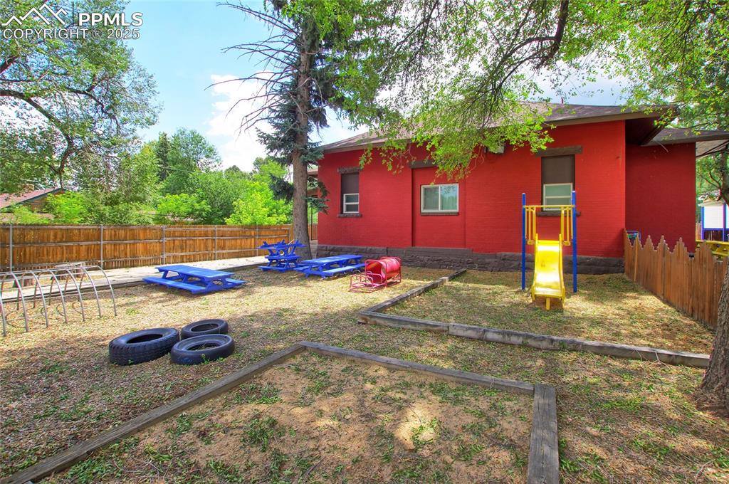 Image 30 of 34: Fenced backyard featuring a vegetable garden