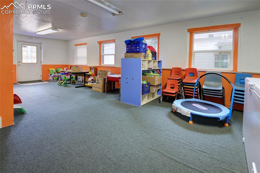 Image 9 of 34: Playroom featuring carpet floors and wainscoting