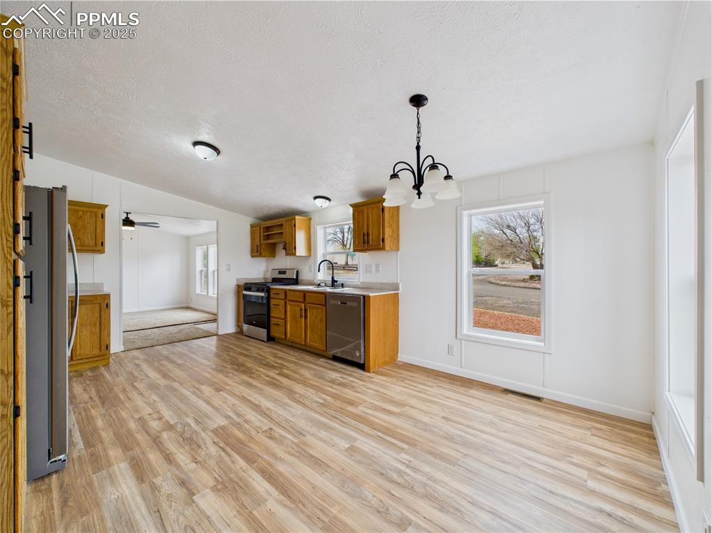 Image 15 of 44: Kitchen with ample space for a dining table or eat-in area