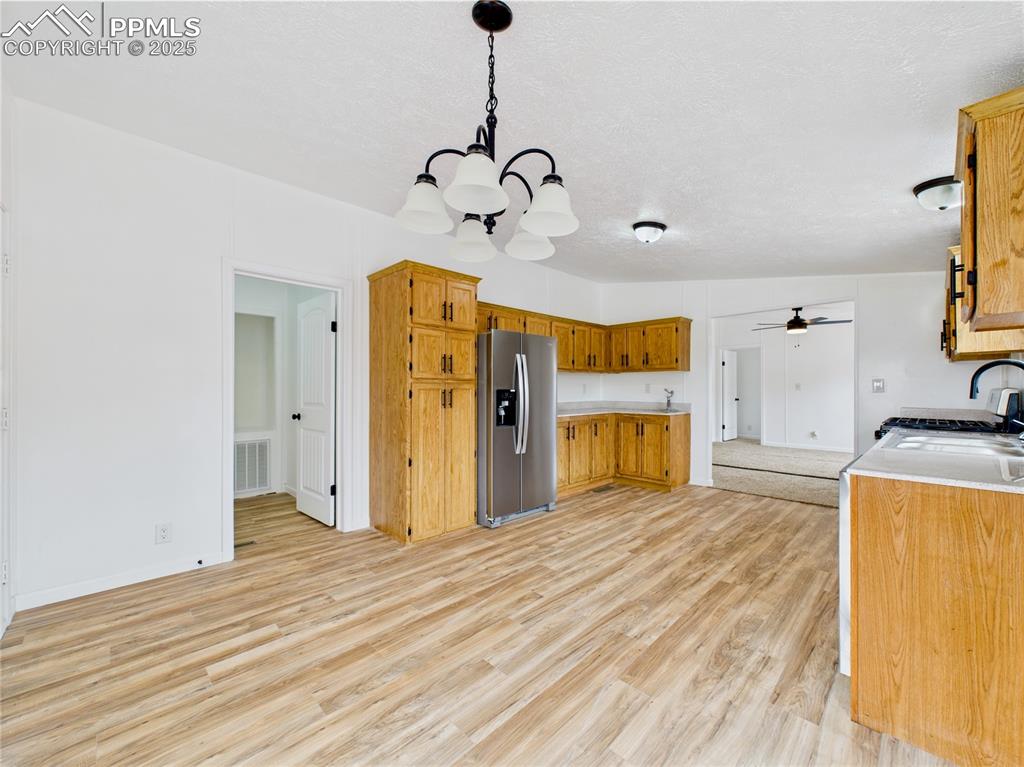 Image 18 of 44: From the kitchen, enjoy sightlines into the living room and nearby laundry