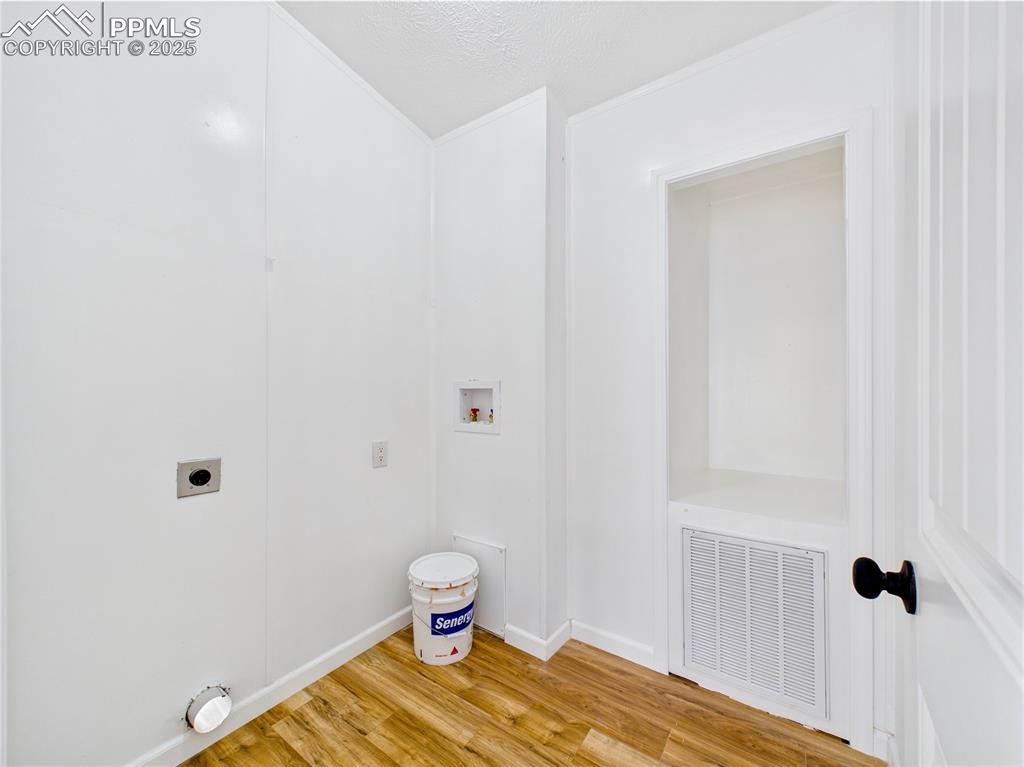 Image 20 of 44: Convenient clothes washing area with electric dryer hookup, washer connecti
