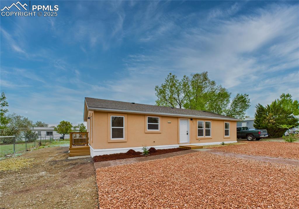Image 40 of 44: Charming single-story home featuring stucco siding and a fully fenced yard
