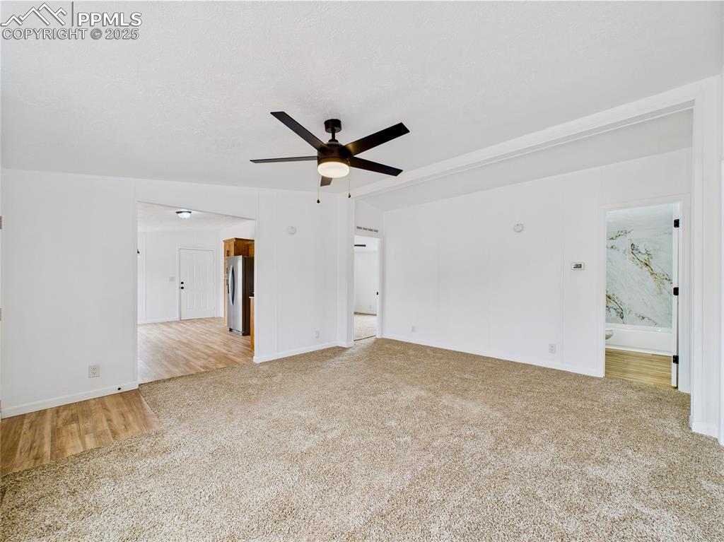 Image 6 of 44: Carpeted main living area perfectly positioned at the center of the home