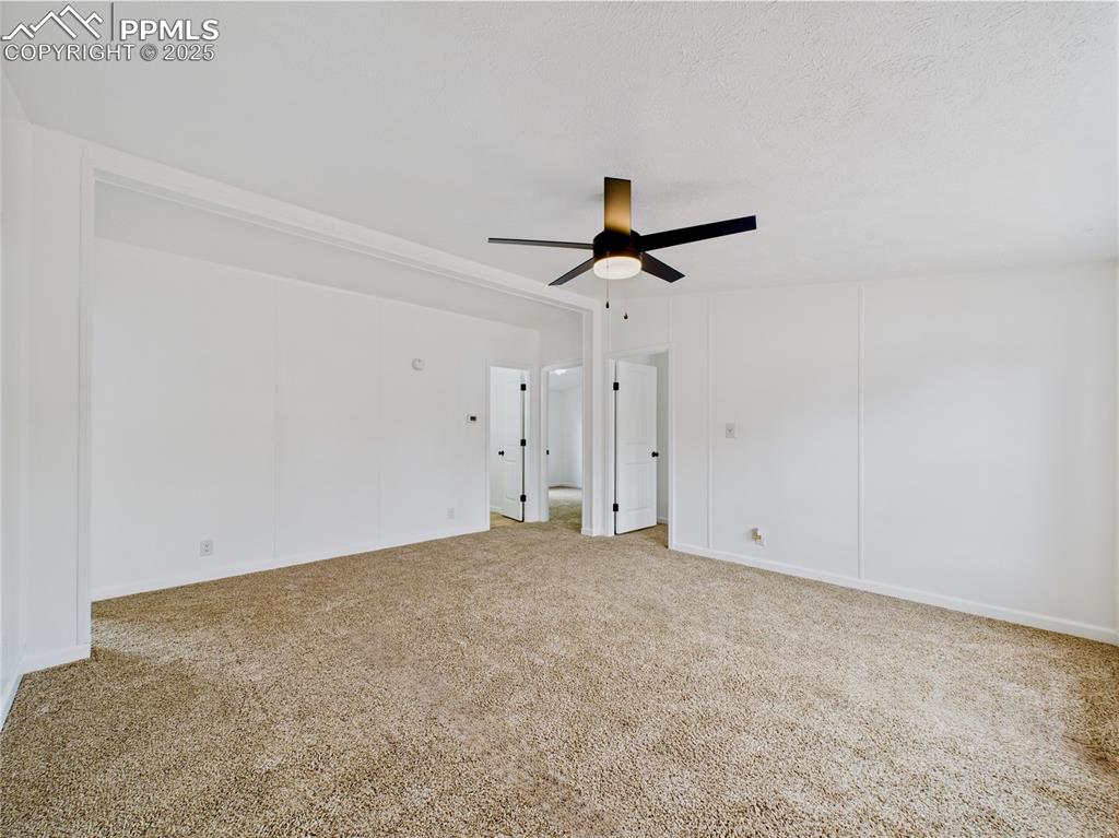 Image 8 of 44: Carpeted living room featuring ceiling fan