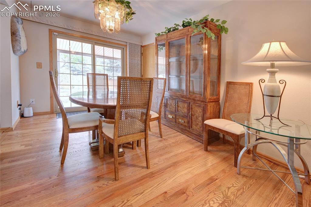 Image 11 of 33: Wood-finish flooring throughout, featuring a multi-pane glass sliding door,