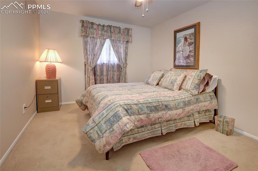 Image 19 of 33: Carpeted room featuring a ceiling fan, neutral wall tones, and a window wit